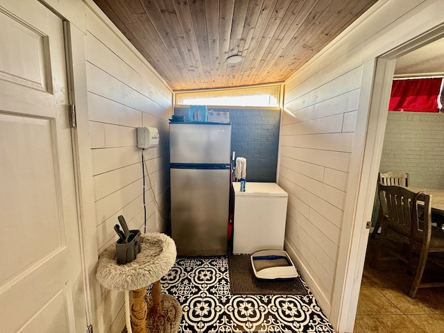 bathroom featuring lofted ceiling, wooden ceiling, brick wall, and wood walls