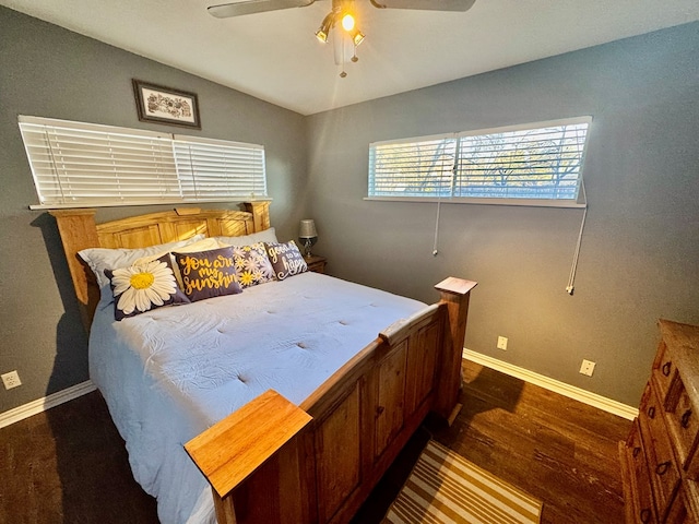 bedroom with ceiling fan and dark hardwood / wood-style floors