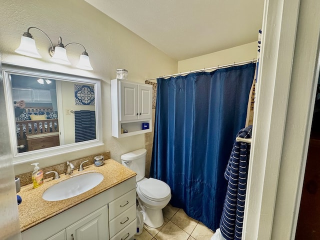 bathroom featuring a shower with curtain, vanity, toilet, and tile patterned flooring