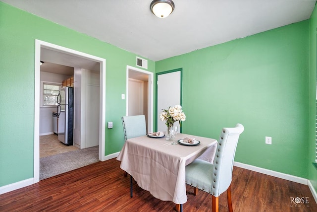 dining area with dark hardwood / wood-style floors