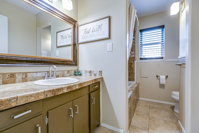 bathroom featuring vanity, toilet, and tile patterned flooring