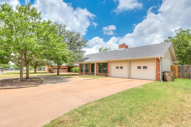 ranch-style house with a garage and a front yard