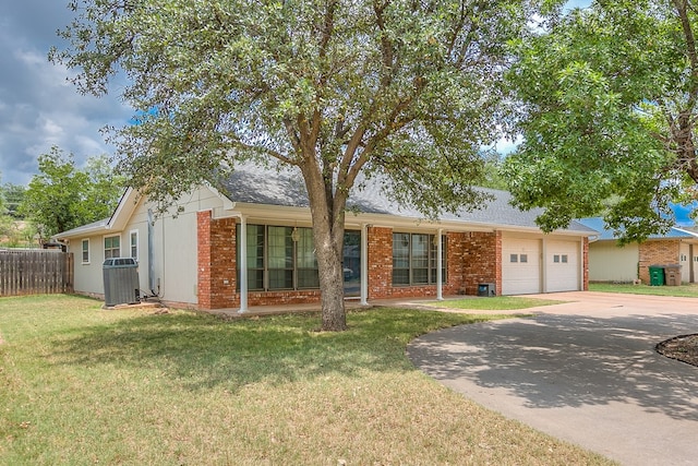 single story home with a garage and a front lawn