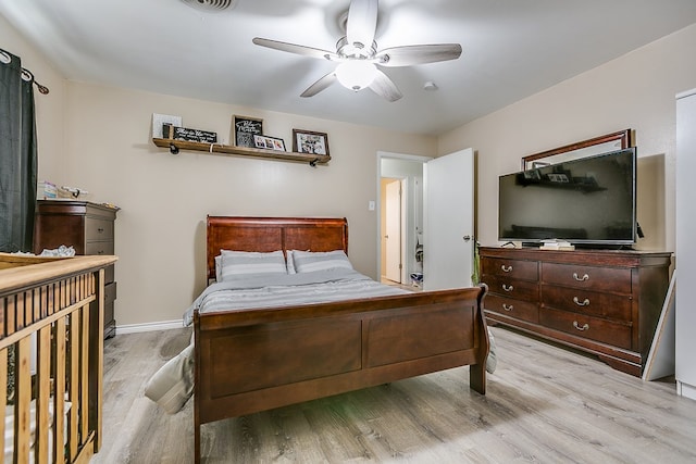 bedroom with ceiling fan and light hardwood / wood-style floors