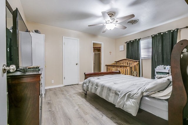 bedroom with ceiling fan and light wood-type flooring