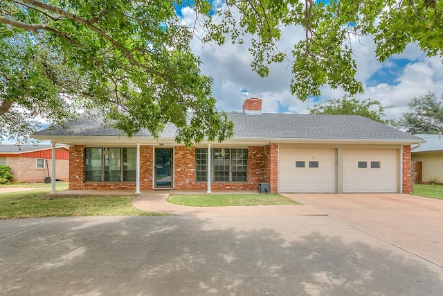 ranch-style house featuring a garage and a front lawn