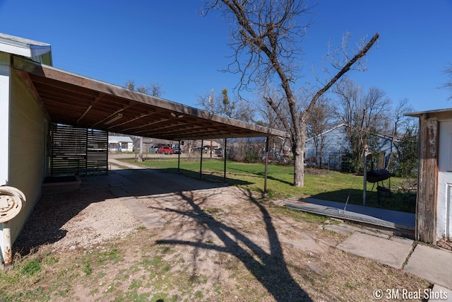 view of vehicle parking with dirt driveway