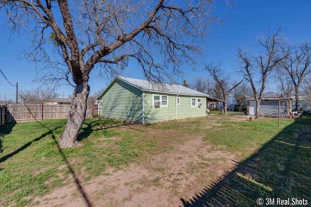 exterior space featuring an outbuilding and fence