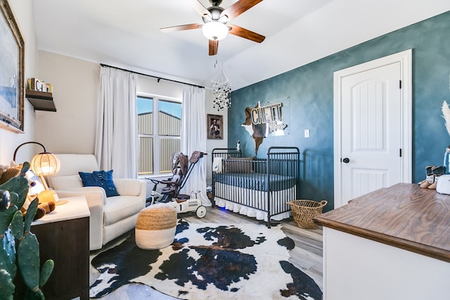 bedroom with lofted ceiling, wood finished floors, and ceiling fan