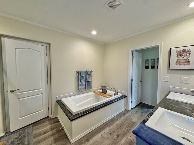 7754 S Copper Mountain Cir, San Angelo, TX 76901 - full bath with wood finished floors, a bath, double vanity, crown molding, and recessed lighting