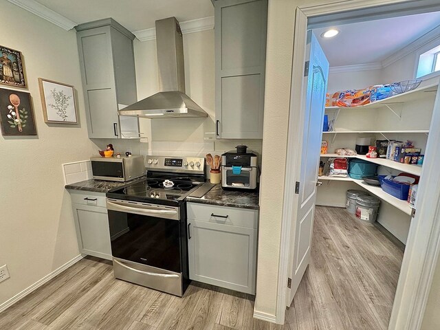 7754 S Copper Mountain Cir, San Angelo, TX 76901 - kitchen with stainless steel appliances, wall chimney range hood, crown molding, light wood-style flooring, and gray cabinets