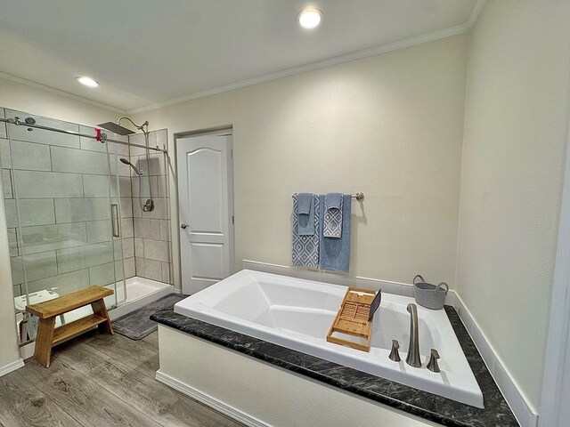 7754 S Copper Mountain Cir, San Angelo, TX 76901 - bathroom with crown molding, a bath, a shower stall, wood finished floors, and recessed lighting