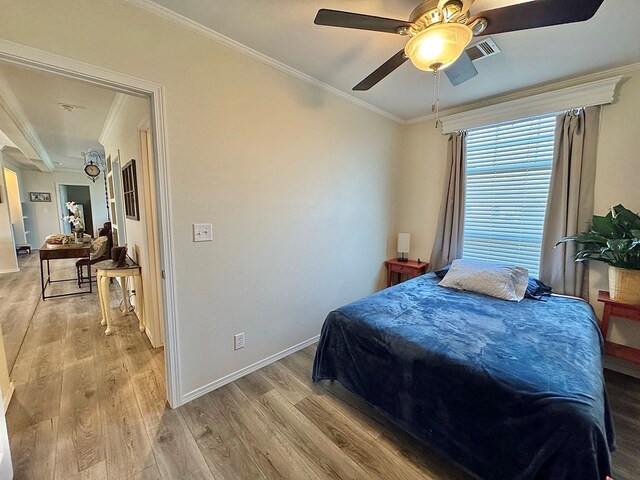 7754 S Copper Mountain Cir, San Angelo, TX 76901 - bedroom featuring crown molding, light wood-style floors, and a ceiling fan