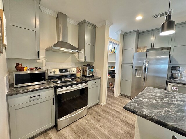7754 S Copper Mountain Cir, San Angelo, TX 76901 - kitchen featuring appliances with stainless steel finishes, wall chimney exhaust hood, ornamental molding, light wood finished floors, and decorative light fixtures