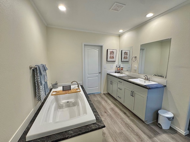 7754 S Copper Mountain Cir, San Angelo, TX 76901 - full bath with double vanity, crown molding, wood finished floors, a bath, and recessed lighting