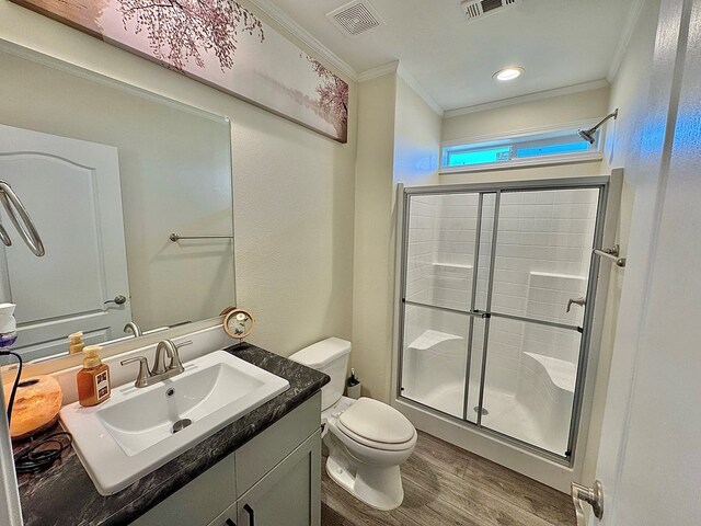 7754 S Copper Mountain Cir, San Angelo, TX 76901 - bathroom featuring crown molding, a shower stall, wood finished floors, and vanity