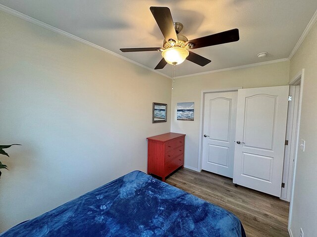 7754 S Copper Mountain Cir, San Angelo, TX 76901 - unfurnished bedroom with wood finished floors, ornamental molding, and a ceiling fan