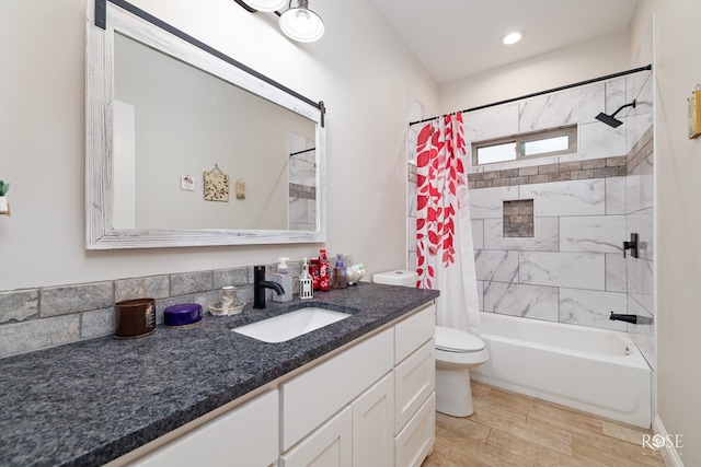 4400 Bobcat Trl, San Angelo, TX 76901 - full bathroom featuring vanity, toilet, shower / bathtub combination with curtain, and wood finished floors