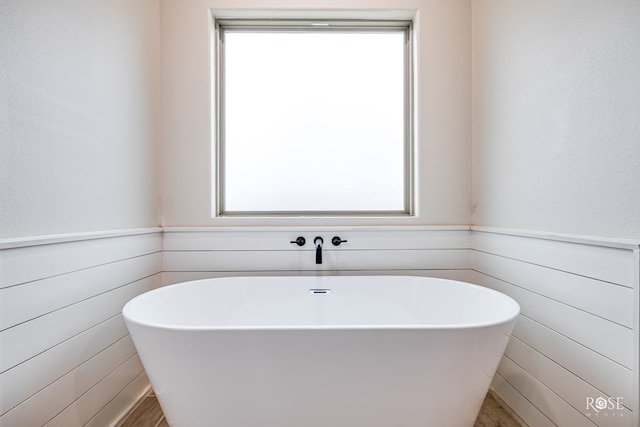 4400 Bobcat Trl, San Angelo, TX 76901 - full bathroom with healthy amount of natural light, a soaking tub, and wood finished floors
