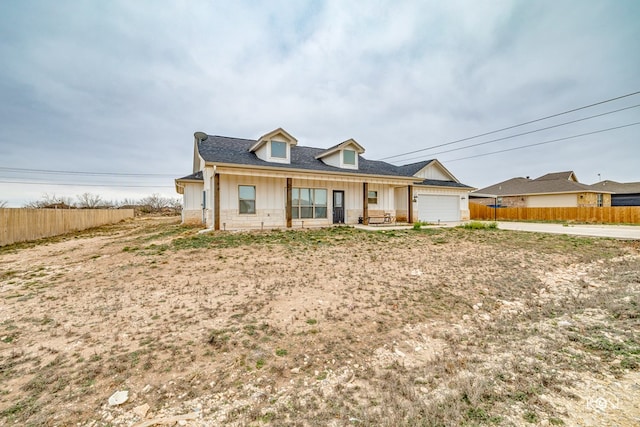 4400 Bobcat Trl, San Angelo, TX 76901 - view of front of home with a garage, concrete driveway, roof with shingles, and board and batten siding