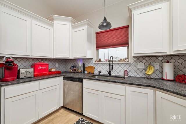 4400 Bobcat Trl, San Angelo, TX 76901 - kitchen featuring stainless steel dishwasher, a sink, decorative backsplash, and white cabinets