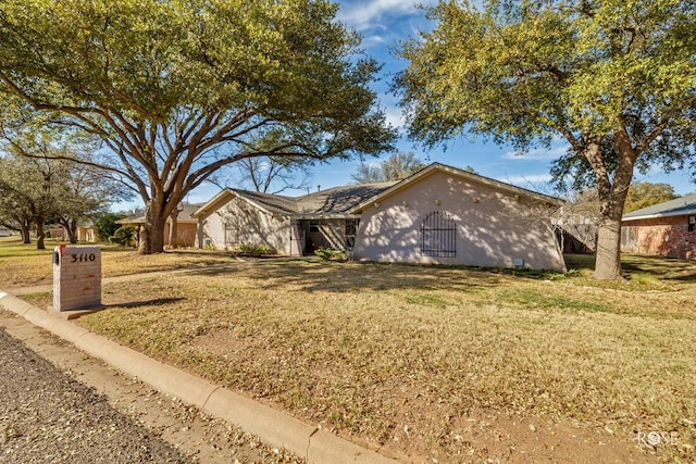 ranch-style house with a front lawn