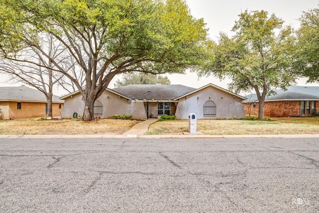 ranch-style home with stucco siding