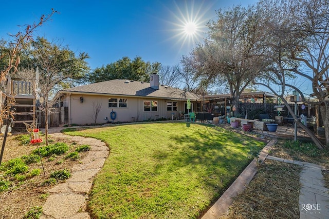 back of house featuring a patio area, a chimney, fence, and a lawn