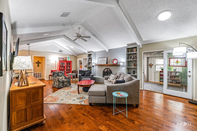 living area featuring lofted ceiling with beams, ceiling fan, a textured ceiling, visible vents, and wood-type flooring