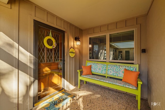 doorway to property with board and batten siding and concrete block siding