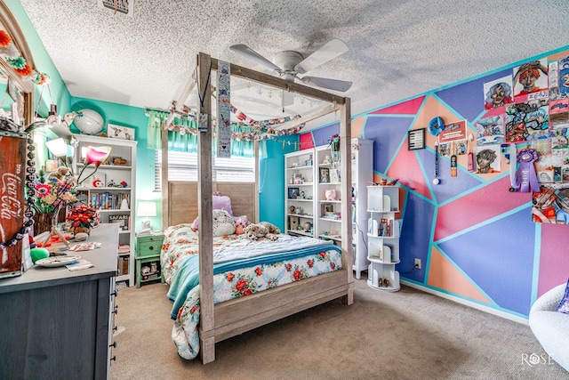 carpeted bedroom featuring a textured ceiling and ceiling fan