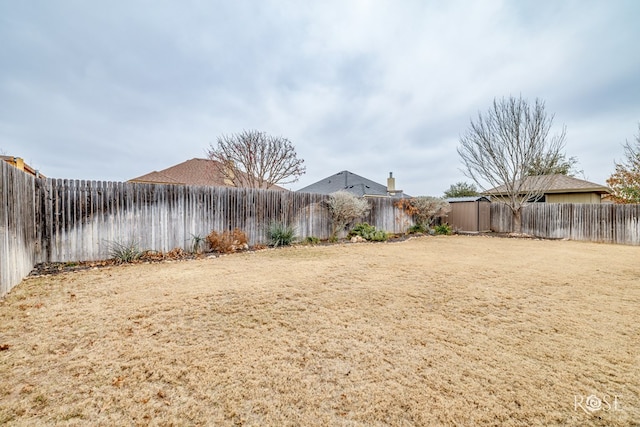 view of yard with a fenced backyard