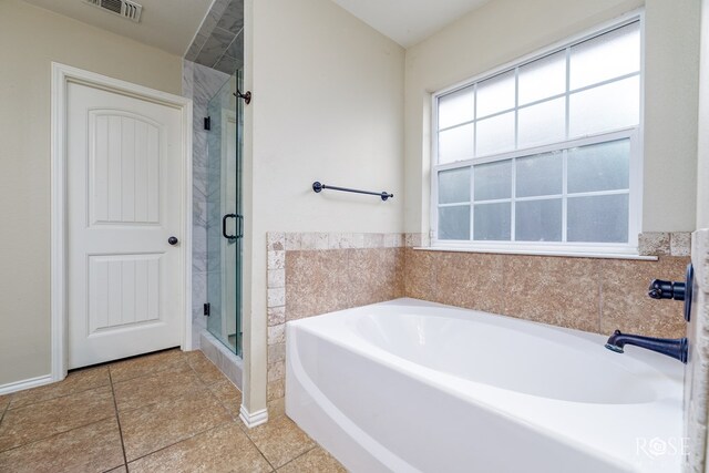 full bathroom featuring a stall shower, visible vents, a bath, and tile patterned floors