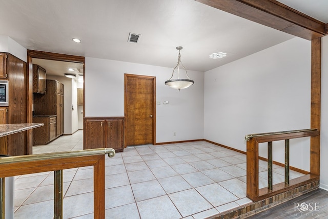 111 Manor St, Sonora, TX 76950 - kitchen with decorative light fixtures, light tile patterned floors, stainless steel microwave, and recessed lighting