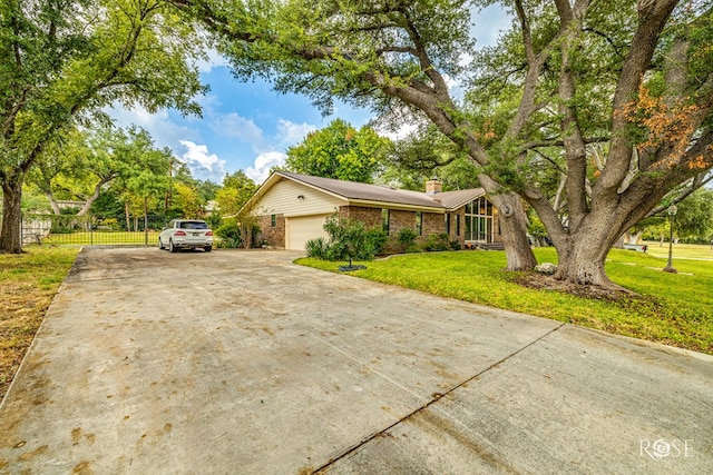 111 Manor St, Sonora, TX 76950 - view of front facade featuring a chimney, a garage, concrete driveway, and brick siding