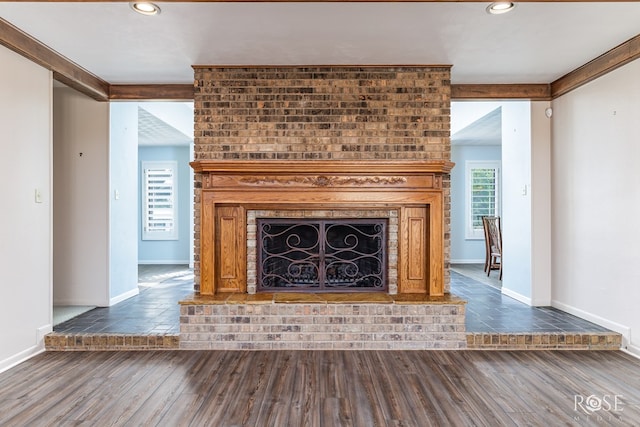 111 Manor St, Sonora, TX 76950 - unfurnished living room with a brick fireplace, wood finished floors, and recessed lighting
