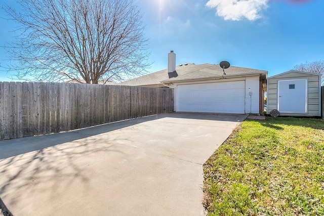 3622 Dominion Rdg, San Angelo, TX 76904 - view of side of home featuring concrete driveway, a garage, and a chimney