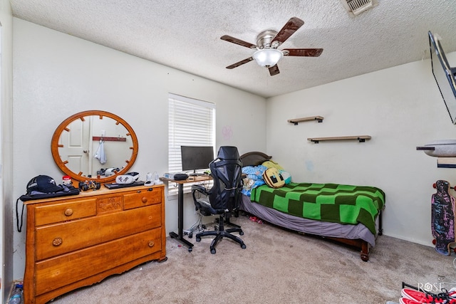 bedroom featuring light colored carpet, a textured ceiling, and ceiling fan