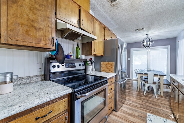 kitchen featuring decorative light fixtures, a textured ceiling, light wood-type flooring, a notable chandelier, and stainless steel electric stove