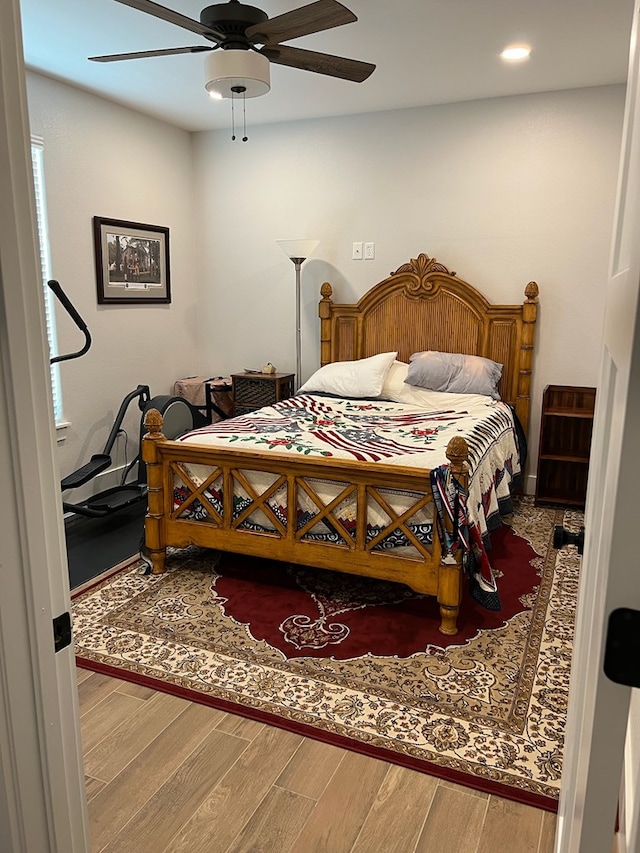 bedroom with a ceiling fan and wood finished floors