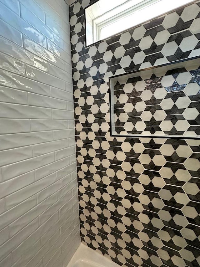 full bathroom with tiled shower