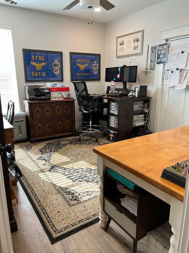 office area with wood tiled floor and ceiling fan