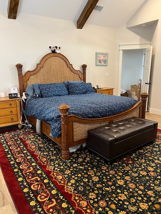 bedroom with vaulted ceiling with beams, baseboards, visible vents, and wood finished floors