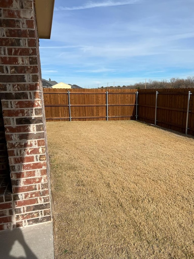 view of yard with a fenced backyard