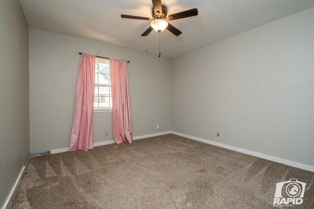 empty room with ceiling fan, baseboards, and carpet floors