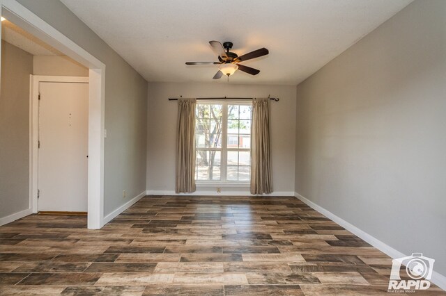 spare room with baseboards, a ceiling fan, and wood finished floors