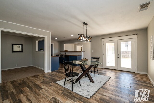 dining space featuring french doors, visible vents, baseboards, and dark wood-style floors