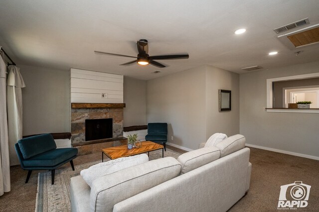 living room featuring a fireplace, baseboards, a ceiling fan, and visible vents