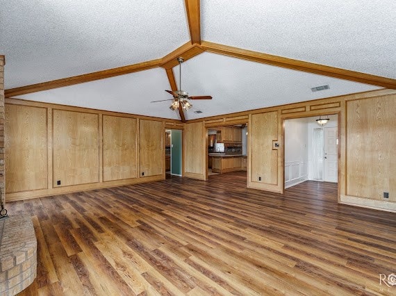 3309 Cedarhill Dr, San Angelo, TX 76904 - unfurnished living room featuring dark wood-style floors, ceiling fan, and wooden walls