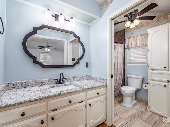 3309 Cedarhill Dr, San Angelo, TX 76904 - bathroom with a ceiling fan, vanity, toilet, and a shower with shower curtain